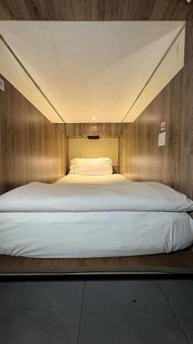 a large bed in a small room with at The Hide Hostel Canggu in Canggu