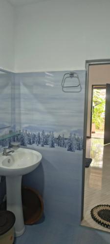 a bathroom with a sink and a shower at Nilaveli Beach Rooms in Nilaveli