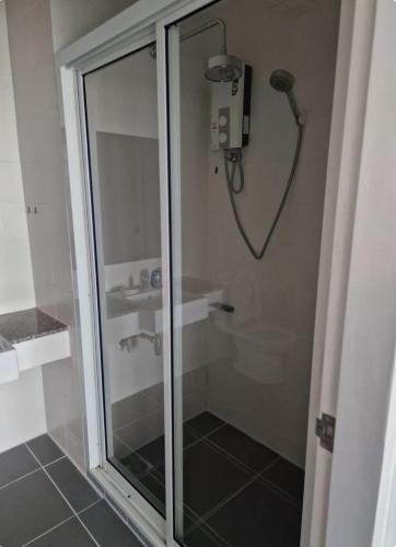 a shower with a glass door in a bathroom at Eid and Philippe's Home building A9 in Ban Ko Kwang
