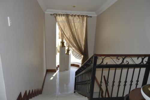 a hallway with a staircase with a window at Lakeview Boutique Hotel & Conference Center in Benoni