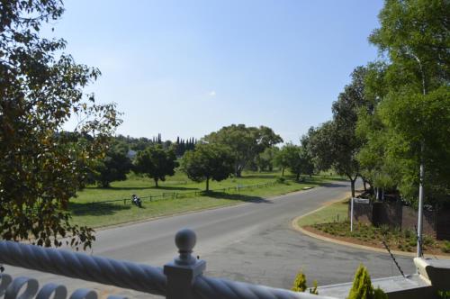 a view from a balcony of a park with a road at Lakeview Boutique Hotel & Conference Center in Benoni
