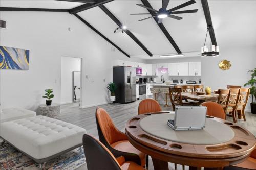a living room with a table with a laptop on it at Sleeps 17! Beach & Heated Pool, 10 minutes to all Tampa attraction! in Tampa