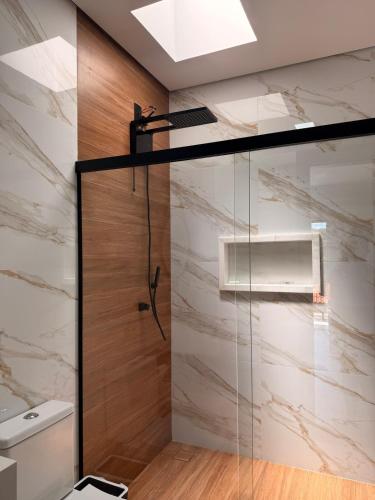 a shower with a glass door in a bathroom at Espaço prime piscina aquecida in Sorocaba