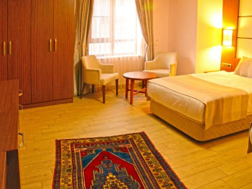 Ένα ή περισσότερα κρεβάτια σε δωμάτιο στο Safa Royal Museum Hotel