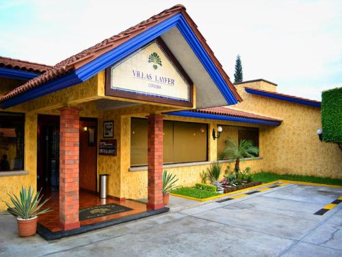 a building with a sign for a villas lender at Villas Layfer, Córdoba, Veracruz, Mexico in Córdoba