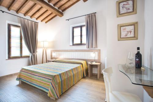 a bedroom with a bed and a glass table at Casale San Galgano in Chiusdino