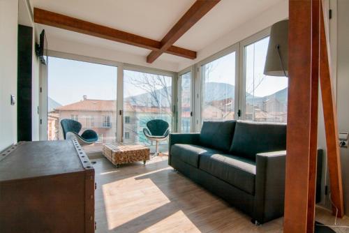 a living room with a couch and a large window at Cal Tonarro in Organyà