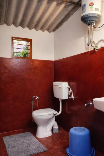 a bathroom with a toilet and a sink at Hallimane Homestay in Udupi