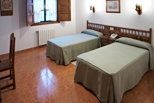 Postel nebo postele na pokoji v ubytování Hospederia Monasterio de Poio