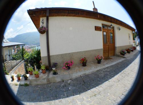 a building with potted plants on the side of it at Villa Ohrid in Ohrid