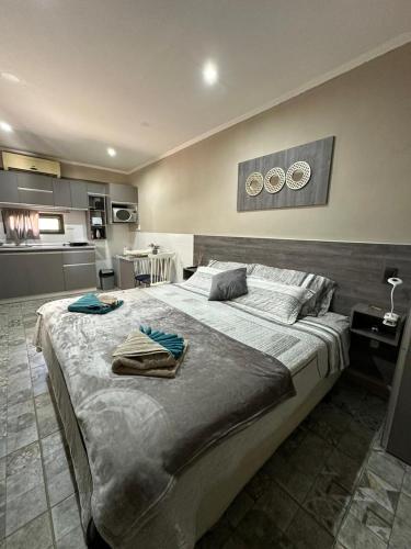 a bedroom with a large bed with two clocks on the wall at Alojamiento La Delfina in Chacras de Coria