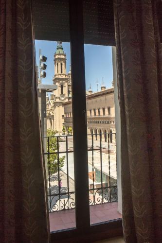 a window with a view of a building at Hotel Tibur in Zaragoza