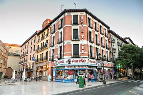 a building on a city street with a store at Hotel Tibur in Zaragoza