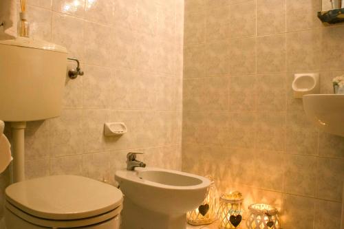 a bathroom with a white toilet and a sink at Domus Hotel in Alessandria