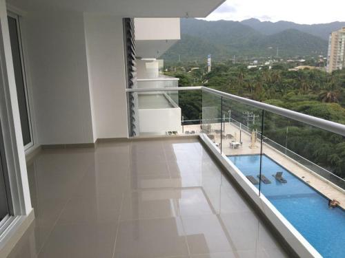 a balcony of a building with a swimming pool at Apartamento Bello Horizonte in Santa Marta