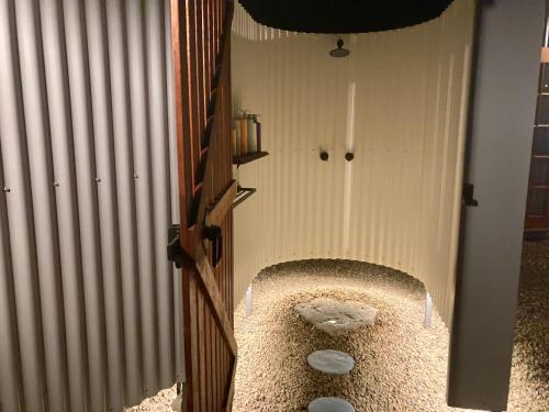 a room with a wall with a door and a floor at Casa Azul - Off-grid Hideaway Agnes Water 1770 in Agnes Water