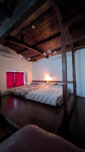 a bedroom with a large bed in a room at CASA DE YOSHi 別館Annex, in Yamagata