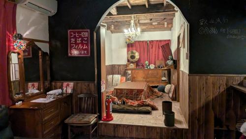 an archway in a room with a bed and a table at CASA DE YOSHi 別館Annex, in Yamagata