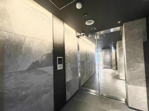 a hallway in a building with a painting on the wall at TIC HOTEL Hisayaodorisakae in Nagoya