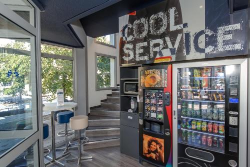 a soda machine in a store with a soda service at ibis budget Aubagne Paluds Agora in Aubagne