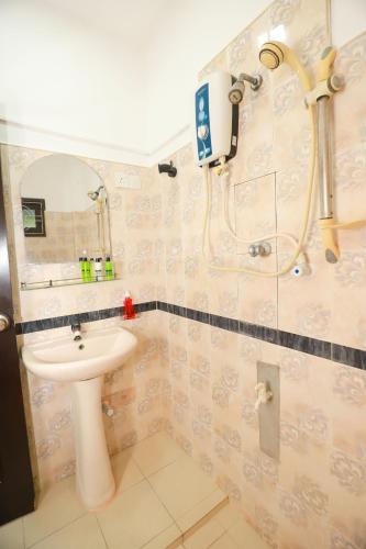 a bathroom with a sink and a shower at Yala Elegant Hotel in Tissamaharama