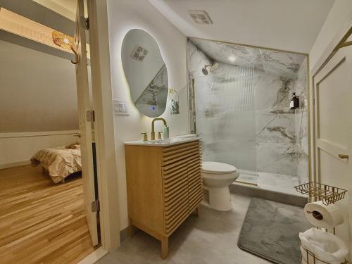 a bathroom with a shower and a toilet and a sink at Spring Rooms by Yale & Downtown in New Haven
