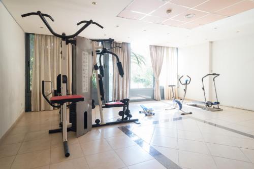 a gym with treadmills and elliptical machines at Acharnis Kavallari Hotel Suites in Athens