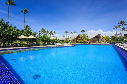 a large blue swimming pool in a resort at Vivá Porto de Galinhas Resort in Porto De Galinhas