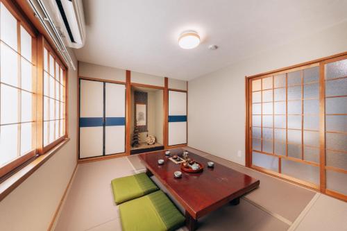 a room with a table and chairs and windows at 子連れ歓迎 平屋一棟貸し 3LDK 最大8名 プレイルーム付 法隆寺徒歩5分 HMV Horyuji in Ikaruga