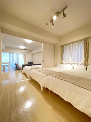 a row of beds in a room at TIC HOTEL Marunouchisakae in Nagoya