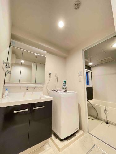 a bathroom with a tub and a sink and a shower at TIC HOTEL Marunouchisakae in Nagoya