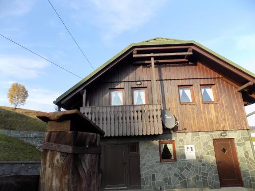 a large wooden house with a balcony on top at Apartment Zeleni dragulj Pohorje in Oplotnica