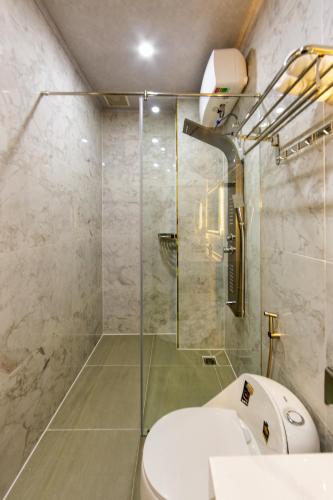 a bathroom with a toilet and a glass shower at Nghia Lan Hotel - Dalat Market in Da Lat