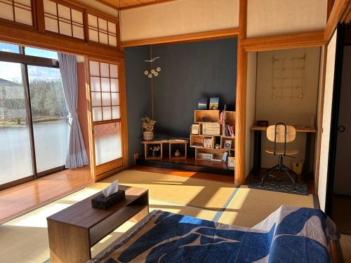 a living room with a bed and a table at Kia Ora Setouchi in Shodoshima