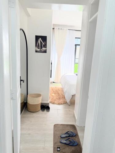 a hallway with a room with a bed and a rug at Kitusuru staycation in Wabuga