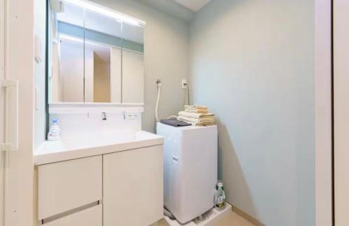 a white kitchen with a sink and a refrigerator at TIC HOTEL NAGOYA Station in Nagoya