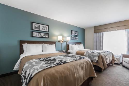 a hotel room with two beds and a window at Sleep Inn & Suites O'Fallon MO - Technology Drive in O'Fallon