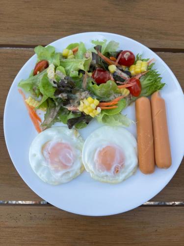 a plate of food with eggs and a salad at Baan Klang Khao Mountain Viewบ้านกลางเขา เมาเทนวิว in Nong Nam Daeng