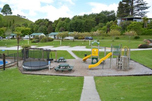 a park with a playground with a slide at Waitomo TOP 10 Holiday Park in Waitomo Caves
