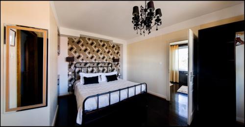 a bedroom with a bed and a chandelier at B&B "Villa Fink" in Ostheim