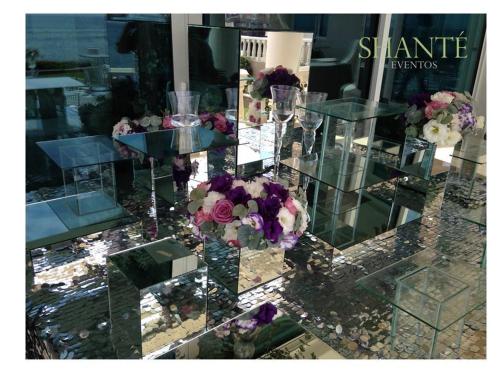 a glass table with a bunch of flowers on it at La Mansión Residency Suites Ensenada in Ensenada