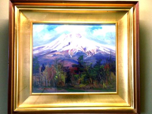 a painting of a mountain in a gold frame at Hotel Sunny Shiga in Yamanouchi