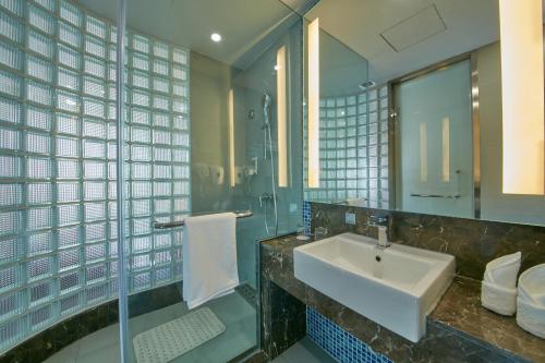 a bathroom with a sink and a mirror at Holiday Inn Express Leshan City Square by IHG High Speed Rail and Leshan Giant Buddha in Leshan