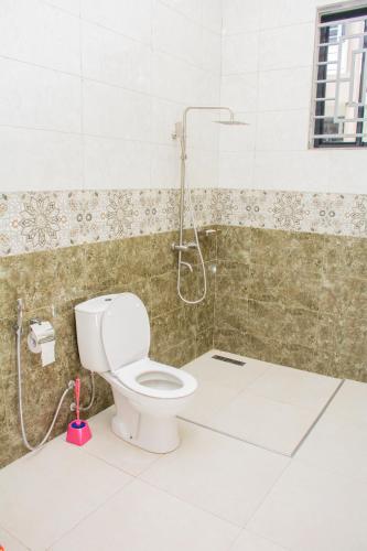 a bathroom with a toilet and a shower at KiliView Homestay in Moshi