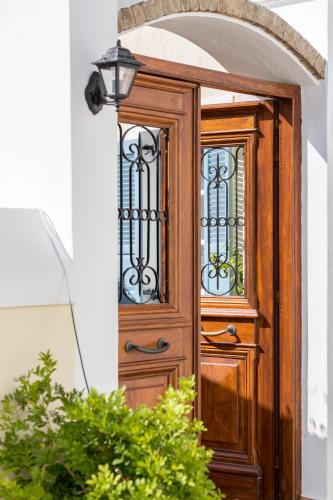 an entry door to a house with a lamp at Guesthouse Niriides in Spetses