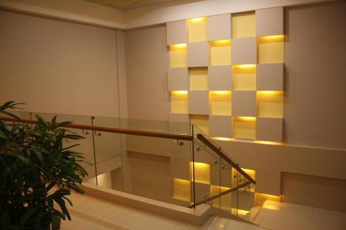 a set of stairs with lights on the wall at Kew Hotel Tagbilaran in Tagbilaran City