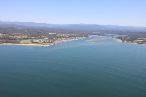 a large body of water with mountains at Quays Hotel in Batemans Bay
