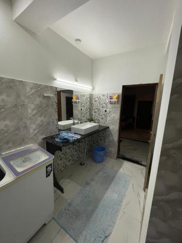 a bathroom with a sink and a mirror at Lotus home in Jaigaon