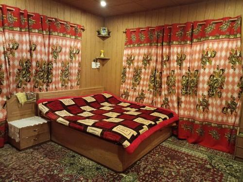 a bedroom with a bed and curtains in a room at Bunk Home stay in Srinagar