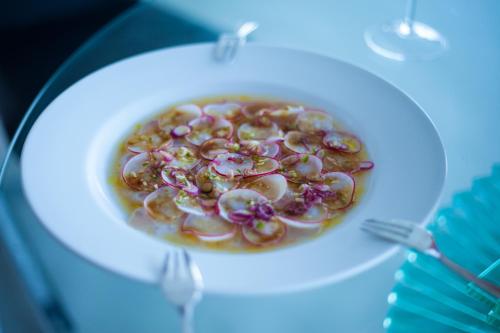 a bowl of food on a plate on a table at Residence William French in Simonʼs Town